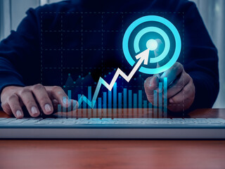 Wall Mural - Return on investment - ROI, business success, profit financial  concepts. Arrow up to target icon to big target icon on digital growth graph pointing by businessman hand while working with computer.