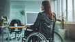 © Ayan - Businesswoman in wheelchair at the desk in her office.