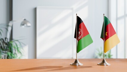 FLAGS OF AFGHANISTAN AND CAMEROON ON TABLE