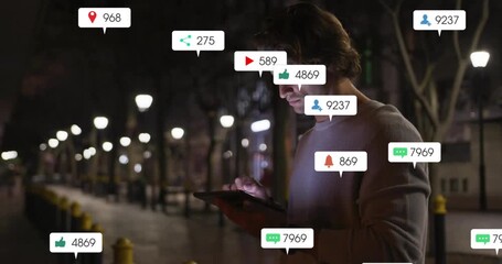 Sticker - Notifications and social media interactions animation over man using tablet at night