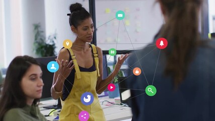 Sticker - Social media icons animation over diverse team discussing in modern office