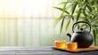 © Pual GotoMars - Enjoy a serene scene featuring a black teapot and two cups of tea on a wooden surface, surrounded by calming bamboo decor.