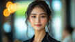 © Bartek - Confident Chinese Businesswoman in Modern Office Setting, Professional Asian Woman Age 30 in Black Suit, Successful Corporate Female with Determined Expression, Workplace Confidence and Leadership