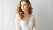 © Oksana - Elegant bride in lace wedding dress with soft curls on light background.Isolated woman in white dress on white background for wedding projects