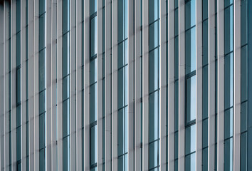 Wall Mural - empty glass windows of a modern building with a reflection of the sky in the glass