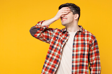 Wall Mural - Young sad mad man he wearing red checkered shirt casual clothes put hand on face facepalm epic fail mistaken omg gesture isolated on plain yellow orange background studio portrait. Lifestyle concept.