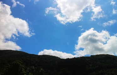 Blue sky and cloud with green mountain.