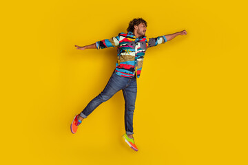 Sticker - Full size photo of pretty young guy flying superman wear trendy colorful outfit isolated on yellow color background