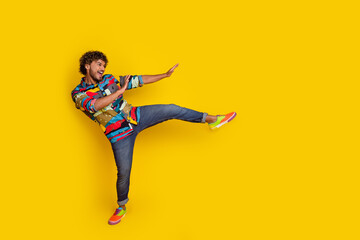 Sticker - Full size photo of pretty young guy dance discotheque have fun wear trendy colorful outfit isolated on yellow color background