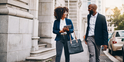 Business, people and walking in city with communication on commute, travel and journey in discussion. Finance, corporate team and employees on sidewalk in talking for planning, briefing or networking