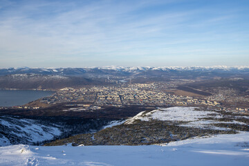 Wall Mural - view from the mountain to the city of magadan. in the distance is a large northern city, located on 
