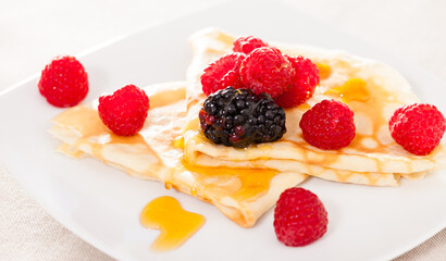 Wall Mural - Pancakes with raspberries, blackberries and honey