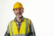 © ChaoticMind - An older man wearing a yellow hard hat and fluorescent safety vest stands against a plain background, portraying a professional in the construction industry.