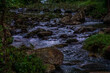 © InfoSoul - A stream of water flows through a rocky area