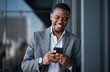 © peopleimages.com - Black man, phone and happy in office for professional career, good news and business opportunity. Human resources, mobile and manager with smile for recruitment, networking and talent acquisition
