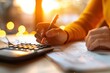 © LazysAI - Close-up of a person writing on a document with a pen and using a calculator, emphasizing finance, accounting, or business tasks in a warm light setting.
