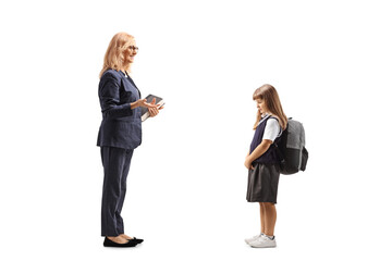 Poster - Full length profile shot of a teacher talking to a sad little schoolgirl