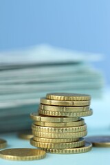 Wall Mural - Stack of euro coins on light blue background, closeup