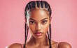 © Surachetsh - Portrait of a young African American woman with braided hair, wearing a pink outfit and full makeup, against a pink studio backdrop.