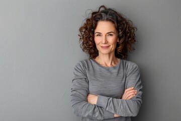 Middle Aged Adult. Cheerful Caucasian Woman with Curly Hair Smiling at Camera