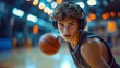 © YUTTADANAI - Young Basketball Player Dribbling on Indoor Court with Headphones Under Bright Lights