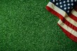© Bundi - Stars and stripes on green grass on top of American flag, labor day concept