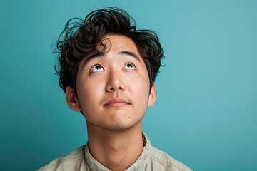 Wall Mural - A man with a beard and a serious look on his face looking up at something