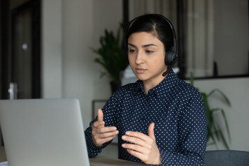 Poster - Young Indian female employee in headset consult client online from home, ethnic millennial woman in earphones speak talk on video call, have WebCam conference with partner or customer on computer