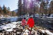 © Studio Peace - Children, brother and sister, in the mountains by a snow-covered river.