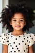 © World of AI - young African American girl, around 6 years old, standing confidently in a cream colored dress with black polka dots