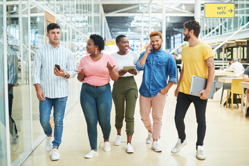 Aufkleber - Walking, group and business people in modern office, technology and internet with connection. App, graphic designers and employees with tablet, smartphone and conversation with network and diversity