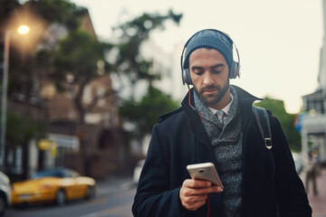 Aufkleber - City, phone and man listening to music, podcast and jazz to travel on work commute in winter. Mobile, outdoor and person streaming audio on headphones for online subscription or scroll social media