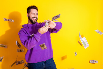 Wall Mural - Photo of positive crazy nice man wear purple trendy clothes waste money empty space isolated on yellow color background