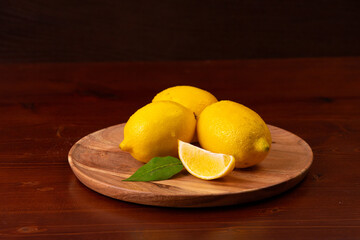 Lemons on a wooden plate