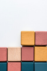 Poster - Colorful wooden blocks arranged in a minimalist pattern against a white background. Ideal for concepts of organization, creativity, and simplicity.