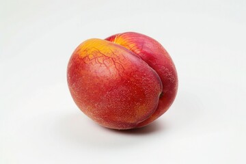 Wall Mural - A ripe, juicy nectarine with a smooth red and yellow skin, isolated on a pure white background