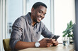 © peopleimages.com - Business man, phone and happy in office for professional career, good news and financial opportunity. Human resources, mobile and manager with smile for recruitment, networking and talent acquisition