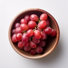 Wall Mural - Upper view of red grapes in a bowl and on white background with copy space, generative IA