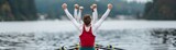 Rowing team celebrates victory with arms raised in the air