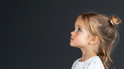 Wall Mural - Side view of French little girl wearing white dress isolated on gray