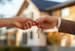 © K KStock - Real estate agent handing keys to new home buyer