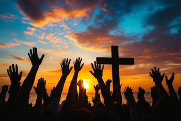 Worshippers raise their hands in praise against a stunning sunset, with the silhouette of a cross highlighting the moment of reverence