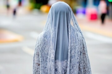 Graceful woman in traditional lace veil blurry city backdrop