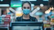 © Popelniushka - Mask Cashier. Young Female Cashier Working at Cash Register with Shallow Focus