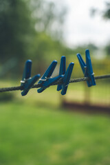 4 Blue Clothespins Hanging on a rope. Clothespins for linen