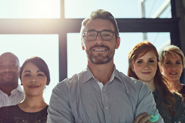 Canvas Print - Happy, employees and manager with arms crossed at office for teamwork, collaboration and about us. People, smile and boss or team leader on portrait for diversity, progress and confident for company