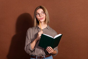 Sticker - Photo of lovely dreamy smart woman wear stylish clothes hand hold book look empty space isolated on brown color background