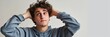 © TheWaterMeloonProjec - A young man appears perplexed with his hands in his hair.