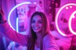 © DK_2020 - Influencer, streamer with phone live streaming in neon bedroom for social media audience, young woman with ring light at home