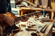 © Nomad_Soul - Technician tuning a guitar in a workshop. Generative AI